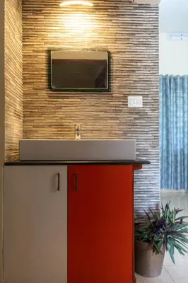 a bathroom with a sink and a red cabinet at CLUB 4 Homestay in Nedumbassery