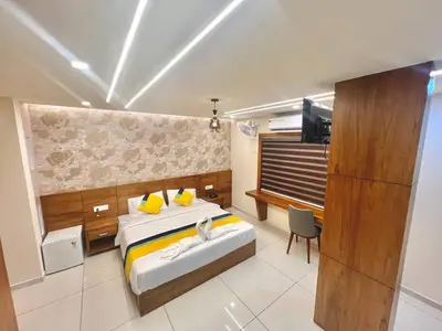 a bedroom with a bed and a television in it at Vilstay Premium- Fathima 2BHK in Kottakkal