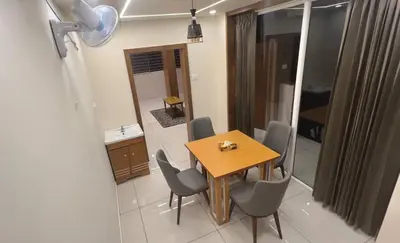 a dining room table and chairs in a room at Vilstay Premium- Fathima 2BHK in Kottakkal