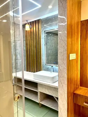 a bathroom with a sink and a mirror at Vilstay Premium- Fathima 2BHK in Kottakkal