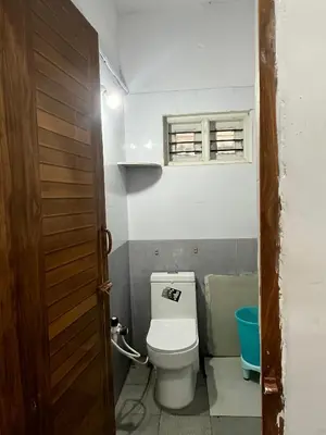 a small bathroom with a toilet and a window at S R Retreat in Dodbelvangala