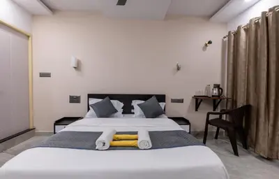 a bedroom with a large bed with towels on it at Coorg Tranquil Retreat in Madikeri