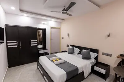 a bedroom with a large bed with a black cabinet at Coorg Tranquil Retreat in Madikeri