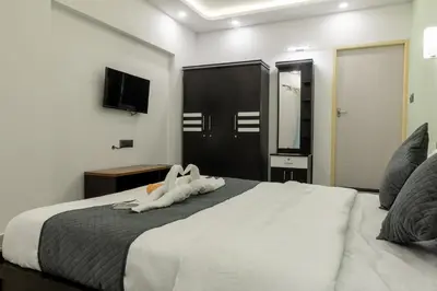 a hotel room with a bed with two towels on it at Coorg Tranquil Retreat in Madikeri