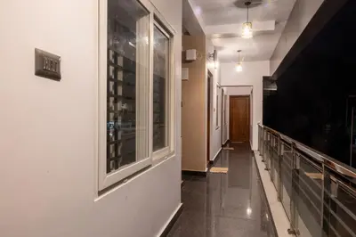 a hallway of a building with a window and a hallway sidx sidx at Coorg Tranquil Retreat in Madikeri