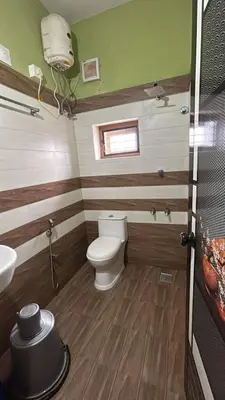 a bathroom with a toilet and a sink at Anugraha inn in Guruvāyūr