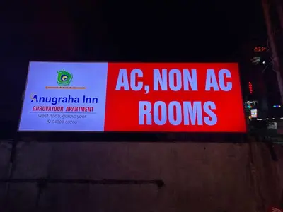 a sign that reads ac amazon inn and non ac rooms at Anugraha inn in Guruvāyūr
