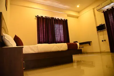 a bedroom with a bed in a room with a window at Daffodil serviced apartments in Mysore