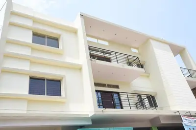 an external view of a white building at Daffodil serviced apartments in Mysore