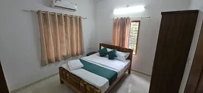 a bedroom with a bed and a window at A cozy home bythe waterstream, tourist places near waynad in Kodenchery