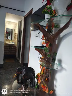 a glass stand with an elephant and a tree at Bhasuri AC Villa with Kitchen 1 in Agali