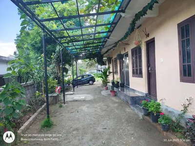 a pergola on the side of a house at Bhasuri AC Room 1 in Agali