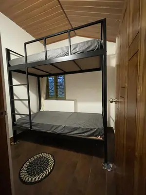 a bedroom with two bunk beds in a room at Naad Alaya Estate Stay in Siddapur