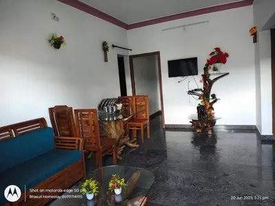 a living room with a couch and a table at Bhasuri Non-AC Room in Agali