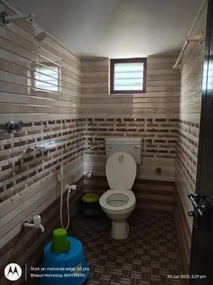 a small bathroom with a toilet in a room at Bhasuri NON-AC Villa with Kitchen in Agali
