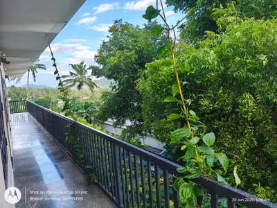 a balcony of a house with trees at Bhasuri NON-AC Villa with Kitchen in Agali