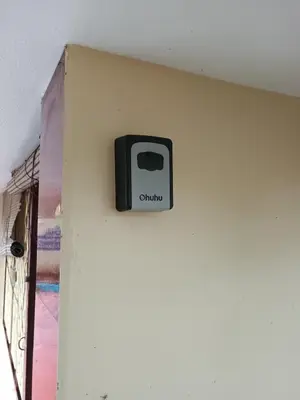 a black clock on the wall of a room at Home away from home in Palakkad in Palakkad