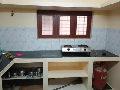 a kitchen with a counter top with a stove at Home away from home in Palakkad in Palakkad