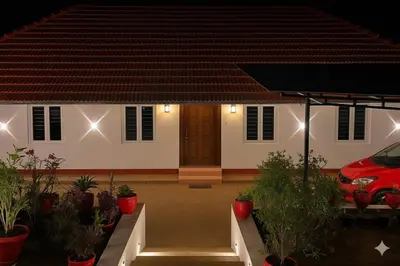 a house with a car parked in front of it at Emnic Cottage Homestay in Meppādi