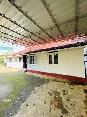 an empty building with a large roof at Emnic Cottage Homestay in Meppādi