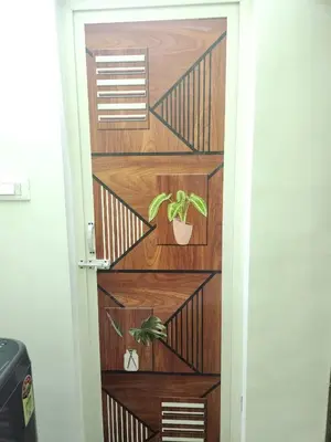 a door with a plant in a pot on it at VPM Homestay in Coimbatore