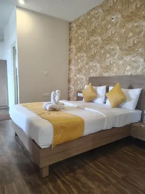 a bedroom with a bed with a stuffed animal on it at North star in Mysore