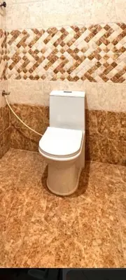 a bathroom with a white toilet in a room at North star in Mysore
