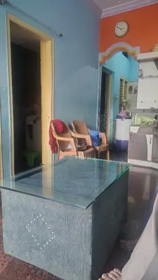 a glass table in a room with two chairs at North star in Mysore