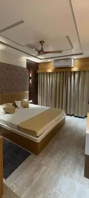 a bedroom with a large bed and a ceiling at North star in Mysore