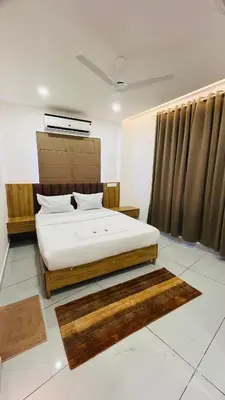 a bedroom with a bed in a room at LF Apartment in Kozhikode