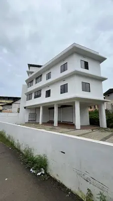 a white building with a lot of windows at LF Apartment in Kozhikode