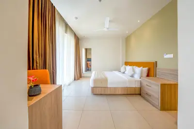 a hotel room with a bed and a desk at MYSA Sky Suites, Lakkidi in Vythiri