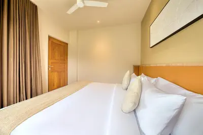 a bedroom with a large bed with white pillows at MYSA Sky Suites, Lakkidi in Vythiri