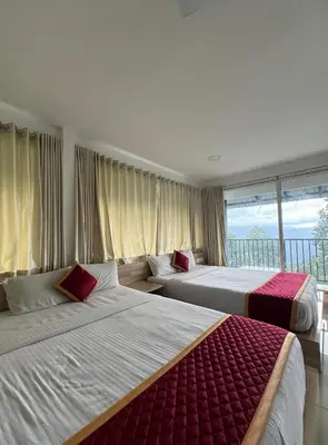 two beds in a hotel room with a balcony at Honeyrock Farm Resort by Skybz in Kanthalloor