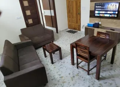a living room with a couch and a table at Sree Guruvayur Inn in Guruvāyūr