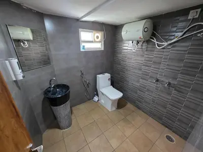 a bathroom with a toilet and a trash can at The Gable in Seringapatam