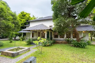 a house with a garden in front of it at Eka in Kodungallūr