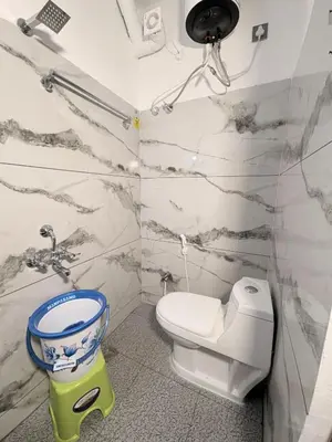 a bathroom with a toilet and a bucket in it at 2 Bedrooms AC Homestay call 8O882-37972 in Mysore