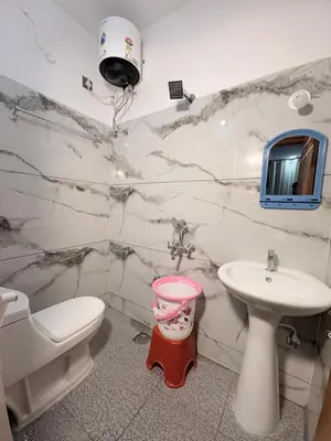 a bathroom with a sink and a toilet and a sink at 2 Bedrooms AC Homestay call 8O882-37972 in Mysore