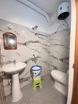 a bathroom with a sink and a toilet at 2 Bedrooms AC Homestay call 8O882-37972 in Mysore