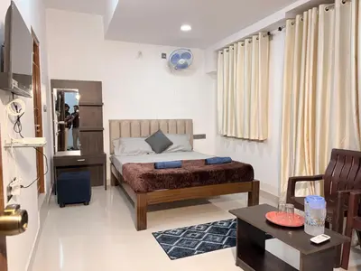 a small bedroom with a bed and a table at 2 Bedrooms AC Homestay call 8O882-37972 in Mysore
