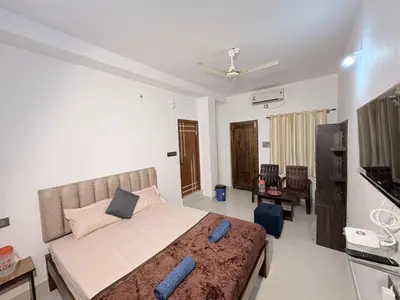 a bedroom with a large bed in a room at 2 Bedrooms AC Homestay call 8O882-37972 in Mysore