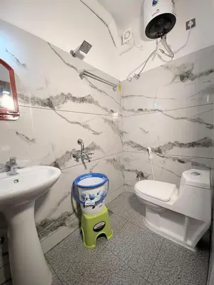 a bathroom with a sink and a toilet at 2 Bedrooms AC Homestay call 8O882-37972 in Mysore
