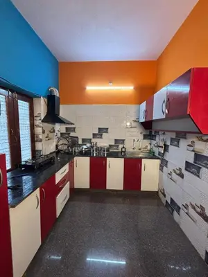 a kitchen with red and white cabinets in a room at Hamsa Farmstay Mysore, Campfire, Bbq, Cricket in Mysore