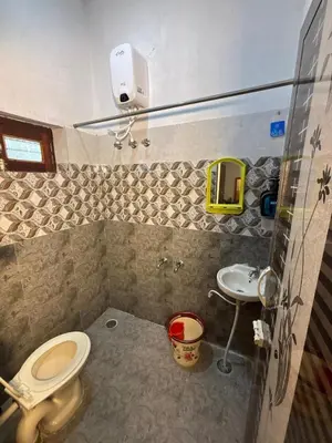 a bathroom with a toilet and a sink at Hamsa Farmstay Mysore, Campfire, Bbq, Cricket in Mysore