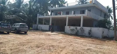 a house with two cars parked in front of it at Hamsa Farmstay Mysore, Campfire, Bbq, Cricket in Mysore