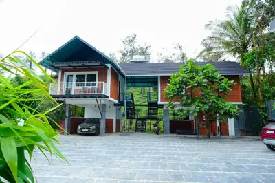 a house with a brick driveway in front of it at Private Pool Villa by Green View in Vythiri