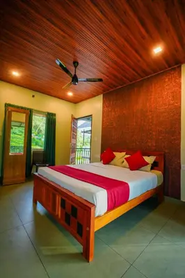 a bedroom with a large bed with a wooden ceiling at Private Pool Villa by Green View in Vythiri