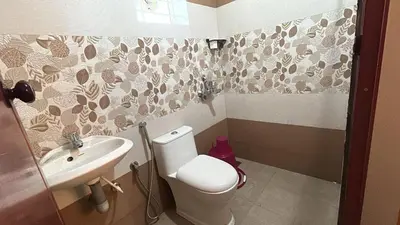 a bathroom with a toilet and a sink at Divin Le Divine 150 meter to temple in Guruvāyūr