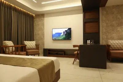 a hotel room with a bed and a waiting room at CASTELO Inn in Nedumbassery